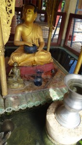 Statue of a bhikkhu with an alms bowl in the Shwezigon complex in Bagan